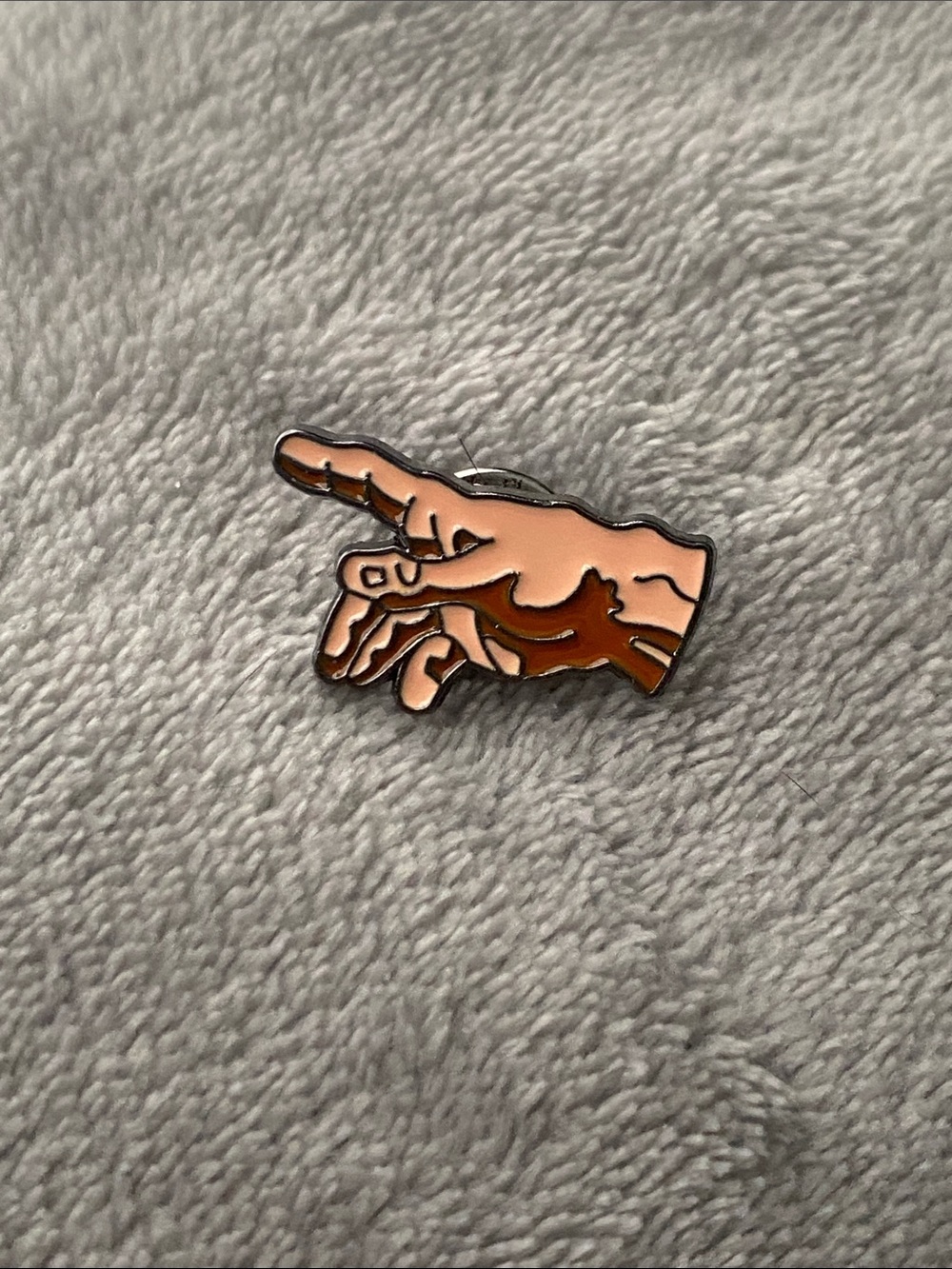Enamel pin of The Creation of Adam hand
